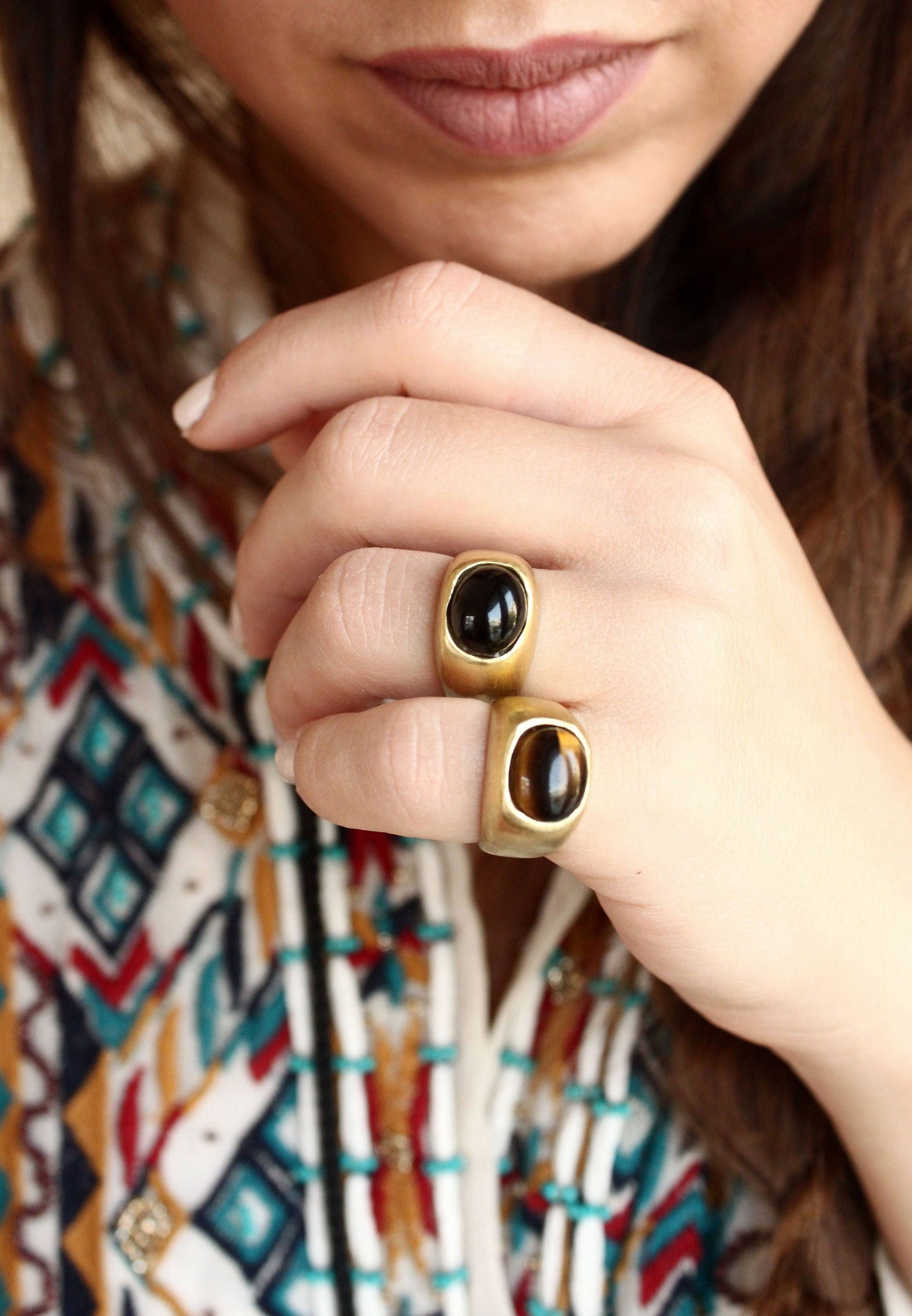  two gold rings with tigers eye dark gemstones