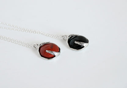 Two pendants with black onyx and red jasper stones