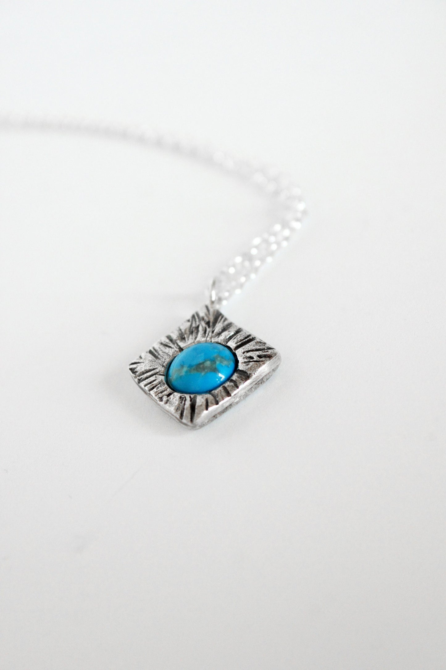 Silver necklace with a turquoise stone pendant 