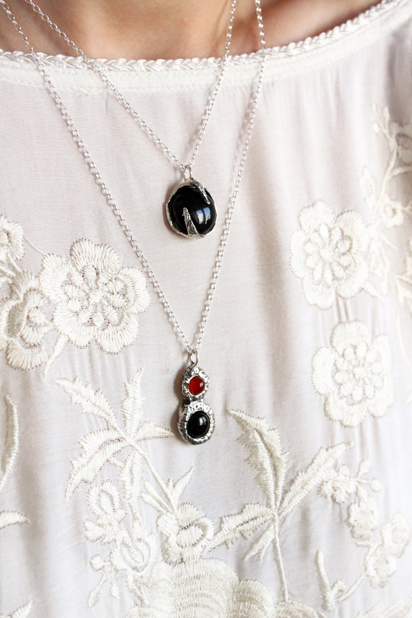 Two necklaces with pendant stones 