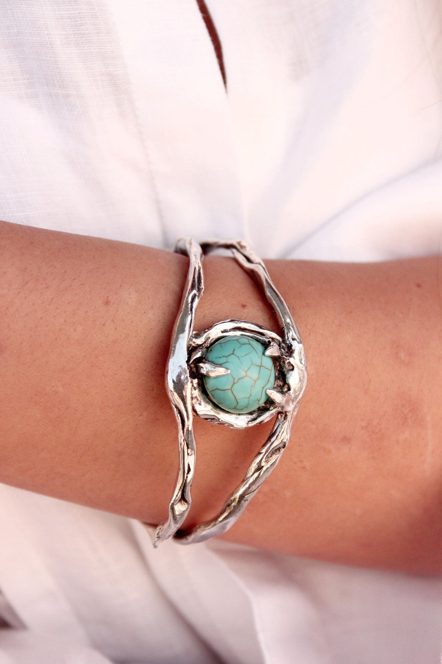Silver evil eye cuff bracelet with a turquoise stone