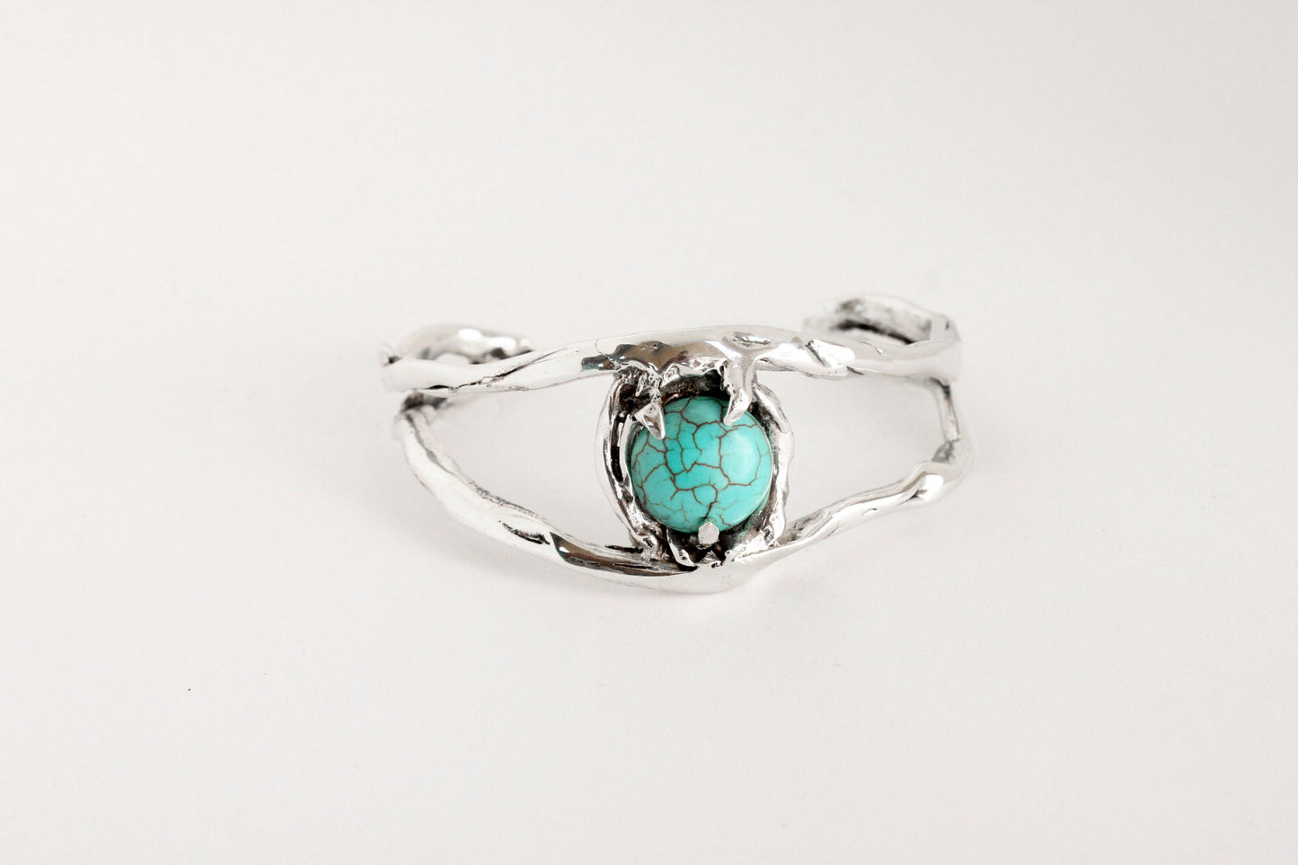 Silver bracelet eye with a turquoise crystal