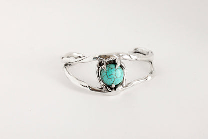 Silver bracelet eye with a turquoise crystal
