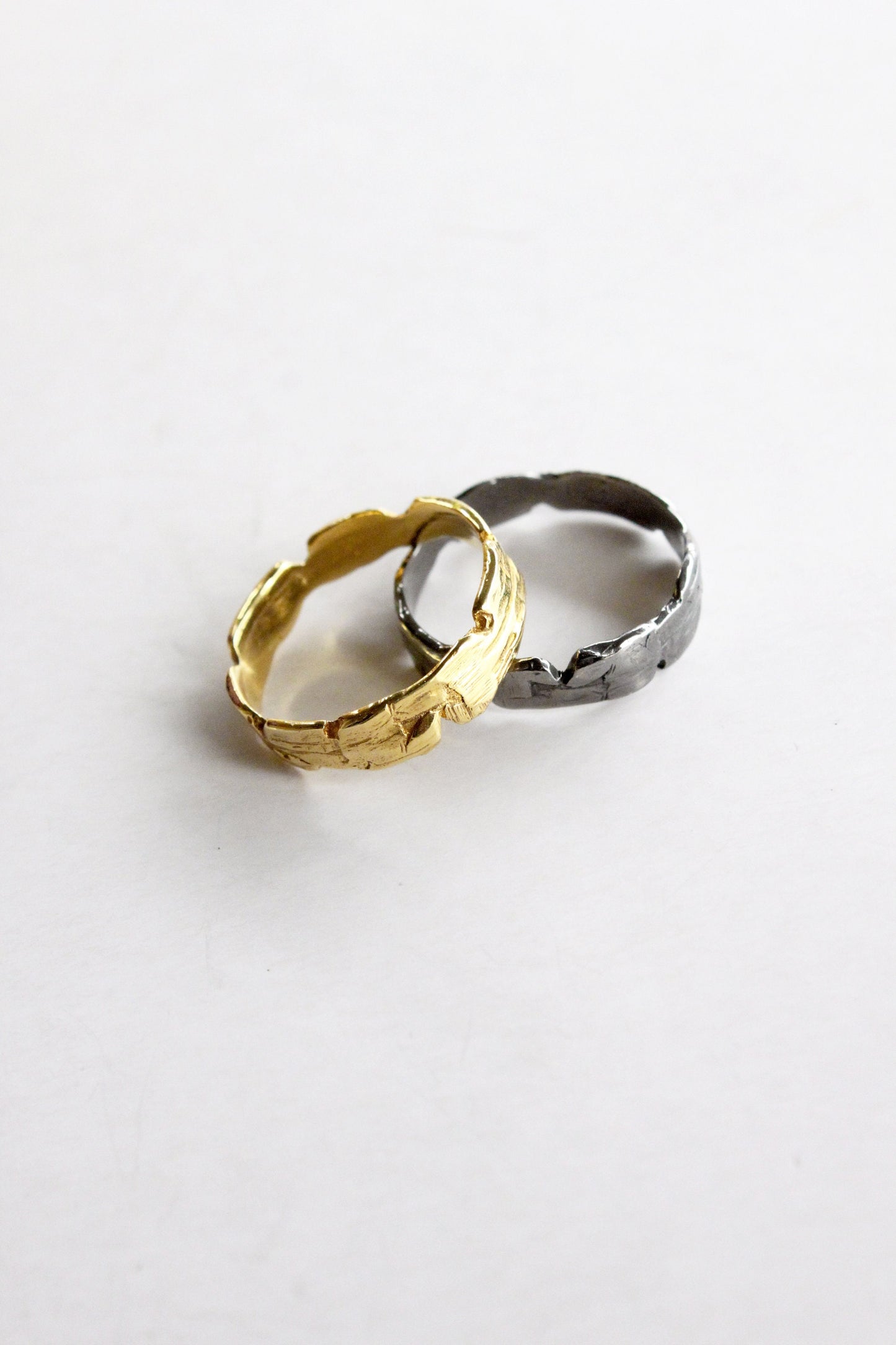 Two rings, one gold and one black sterling silver