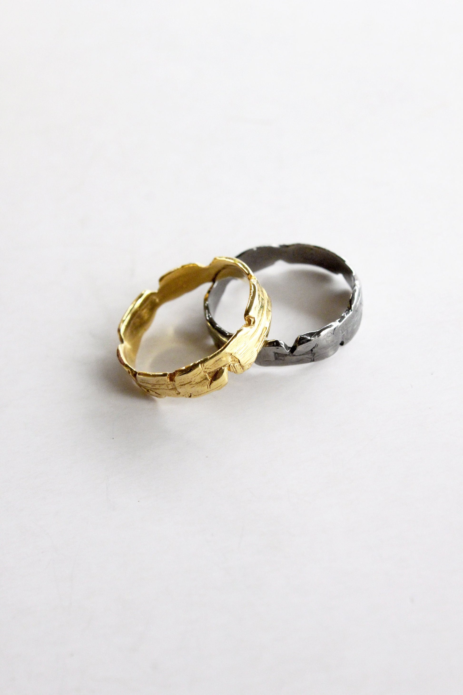 Two rings, one gold and one black sterling silver