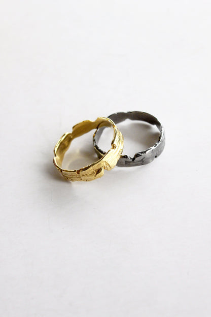Two rings, one gold and one black sterling silver