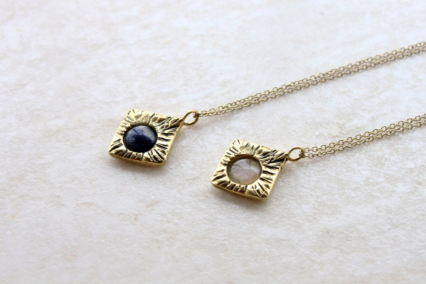 Two gold necklaces with gemstones