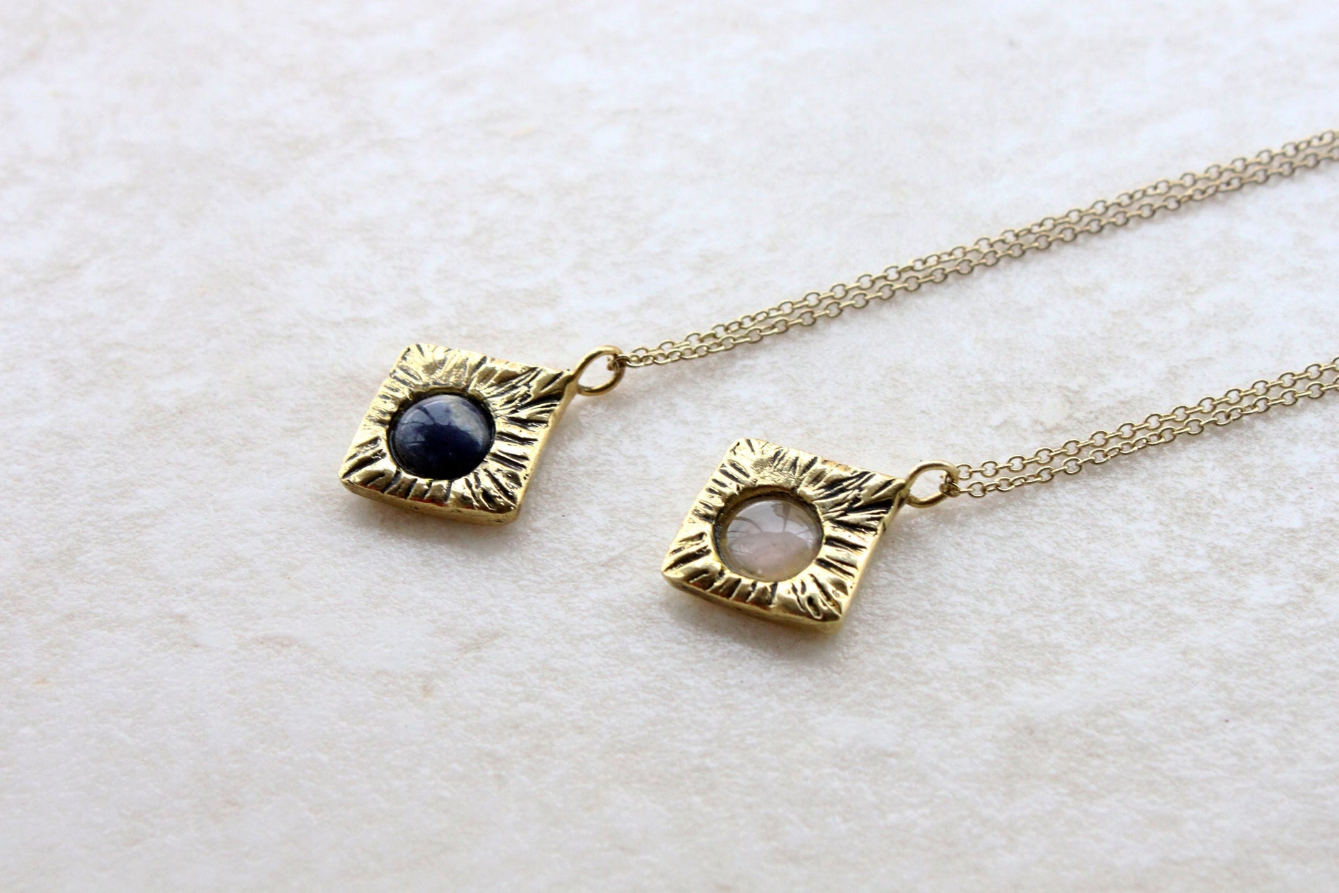 Two gold necklaces with gemstones