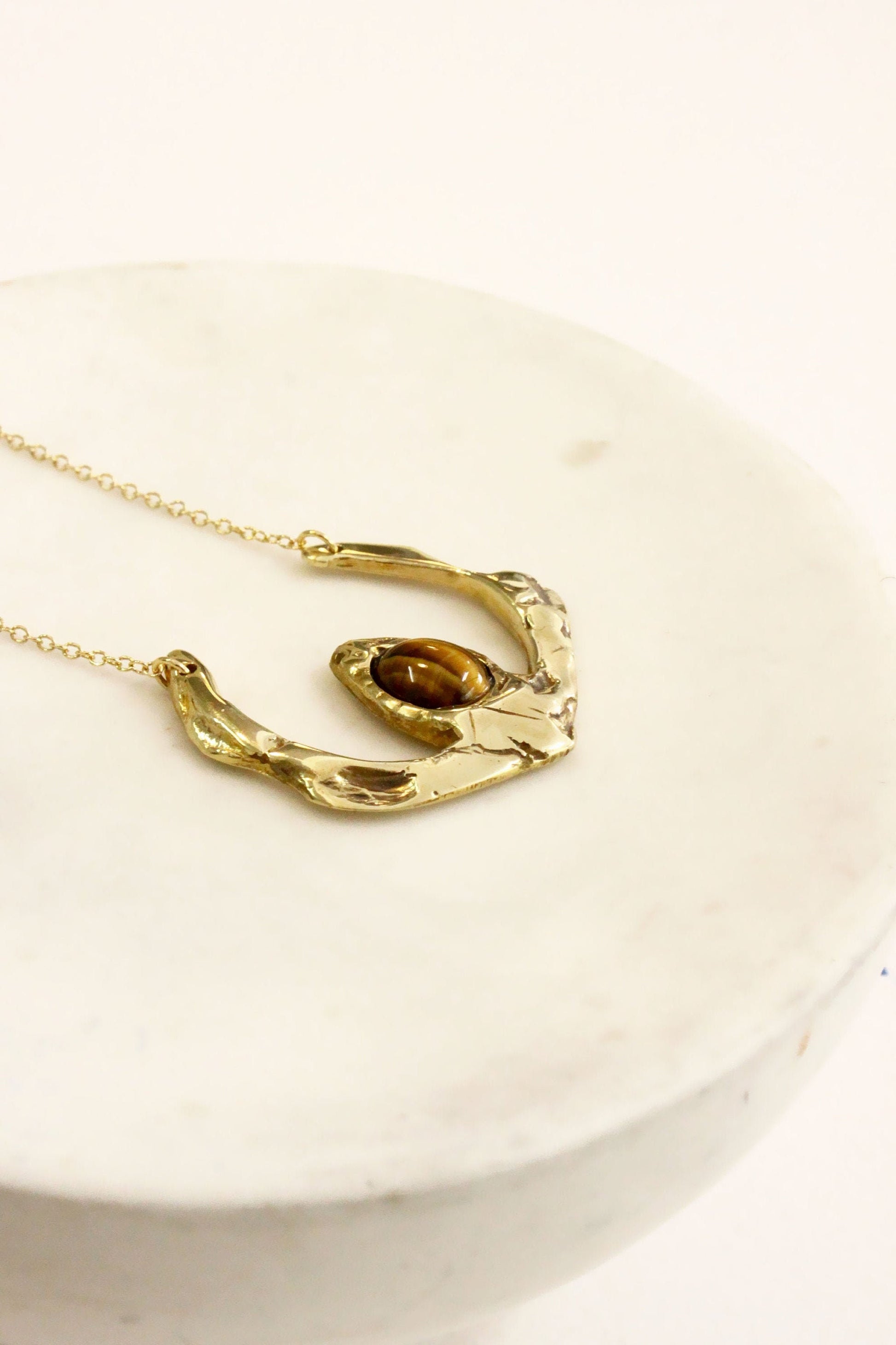 Gold necklace with a unique tigers eye crystal