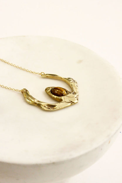 Gold necklace with a unique tigers eye crystal