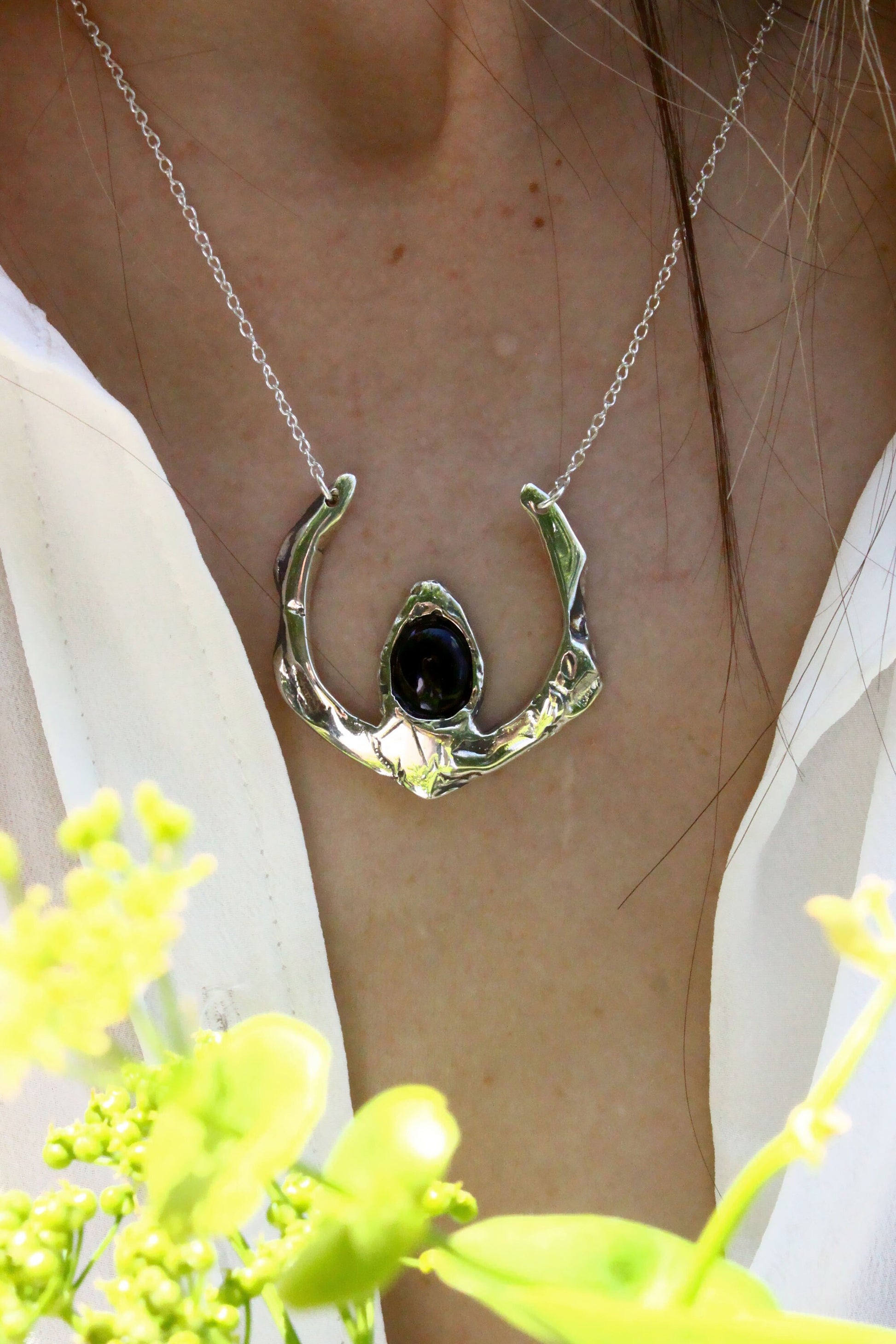Silver necklace with a black pendant 