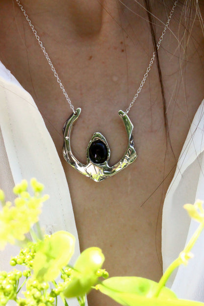 Silver necklace with a black pendant 