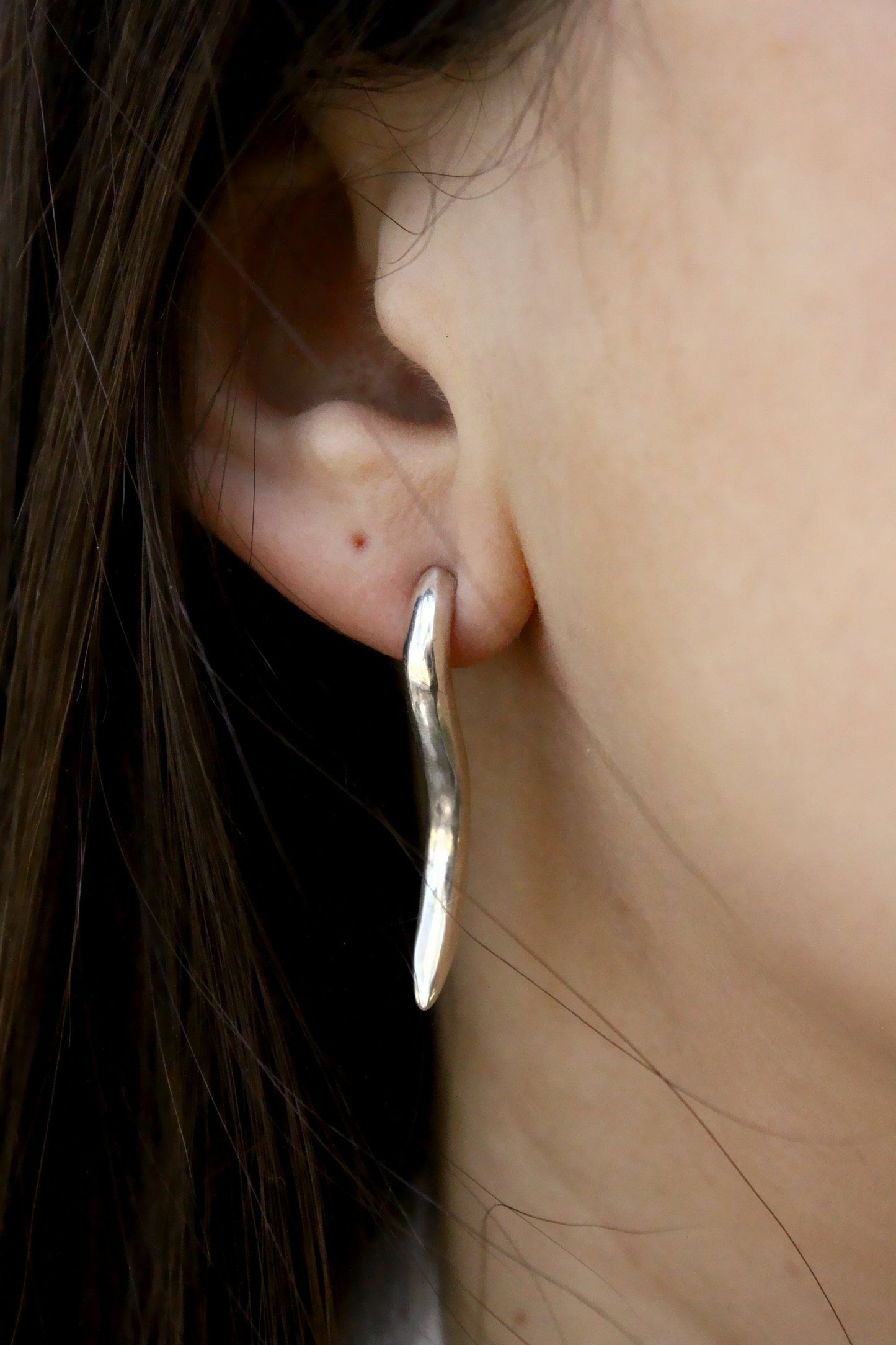 Sterling silver horn earring.
