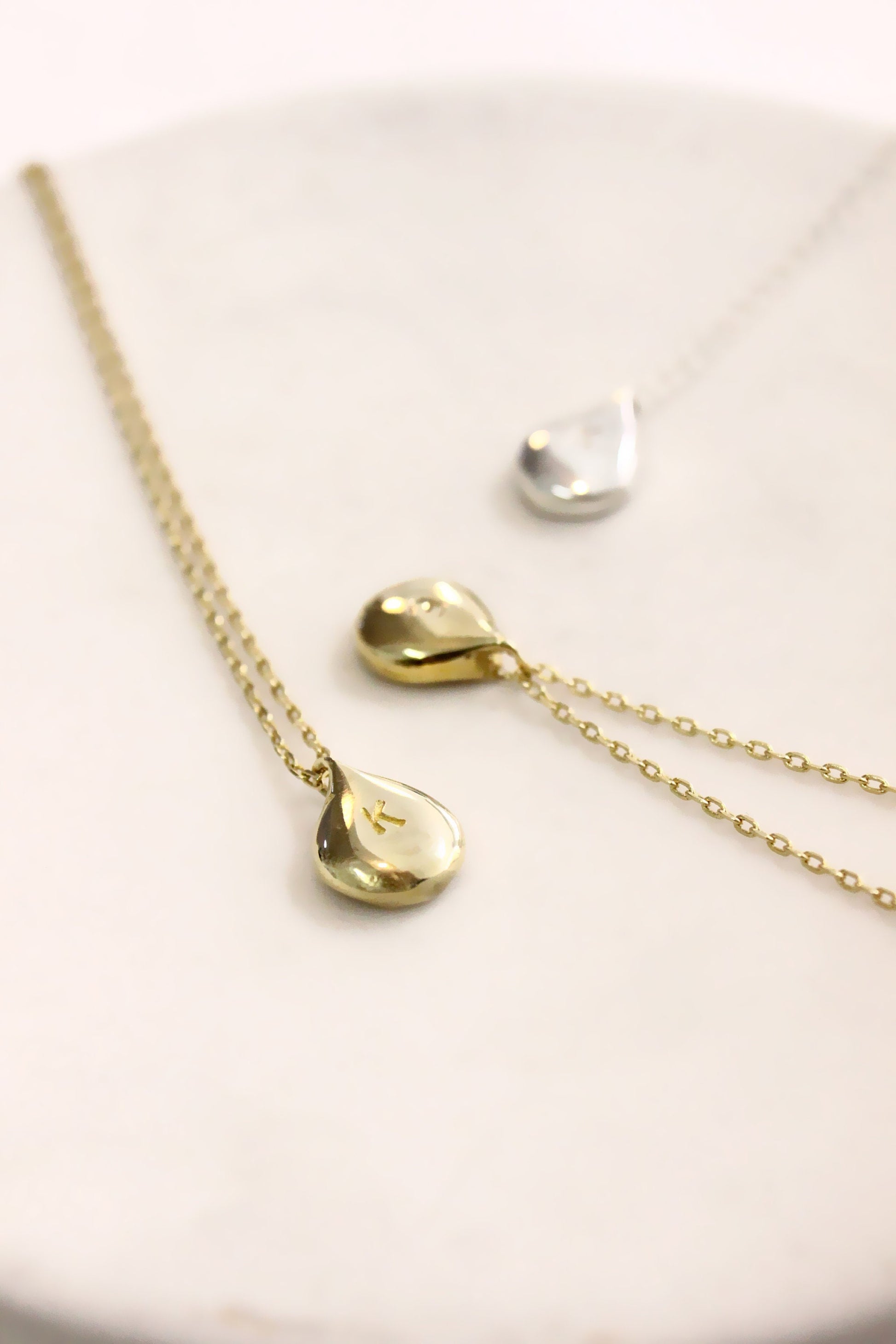 Gold necklace with teardrop pendants monogram