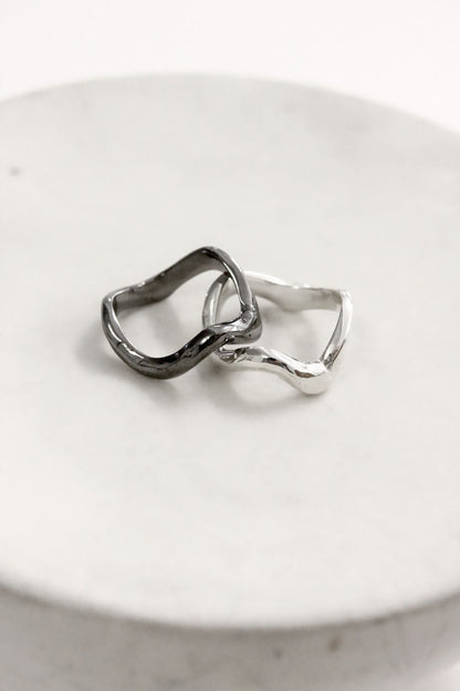 Two silver rings wavy molten liquid 