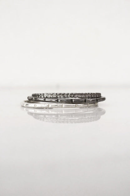 Stack of silver minimal bar cuff 