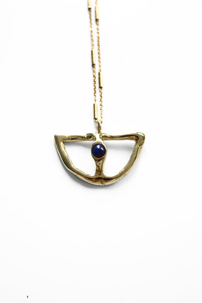 Gold necklace with a blue gemstone pendant