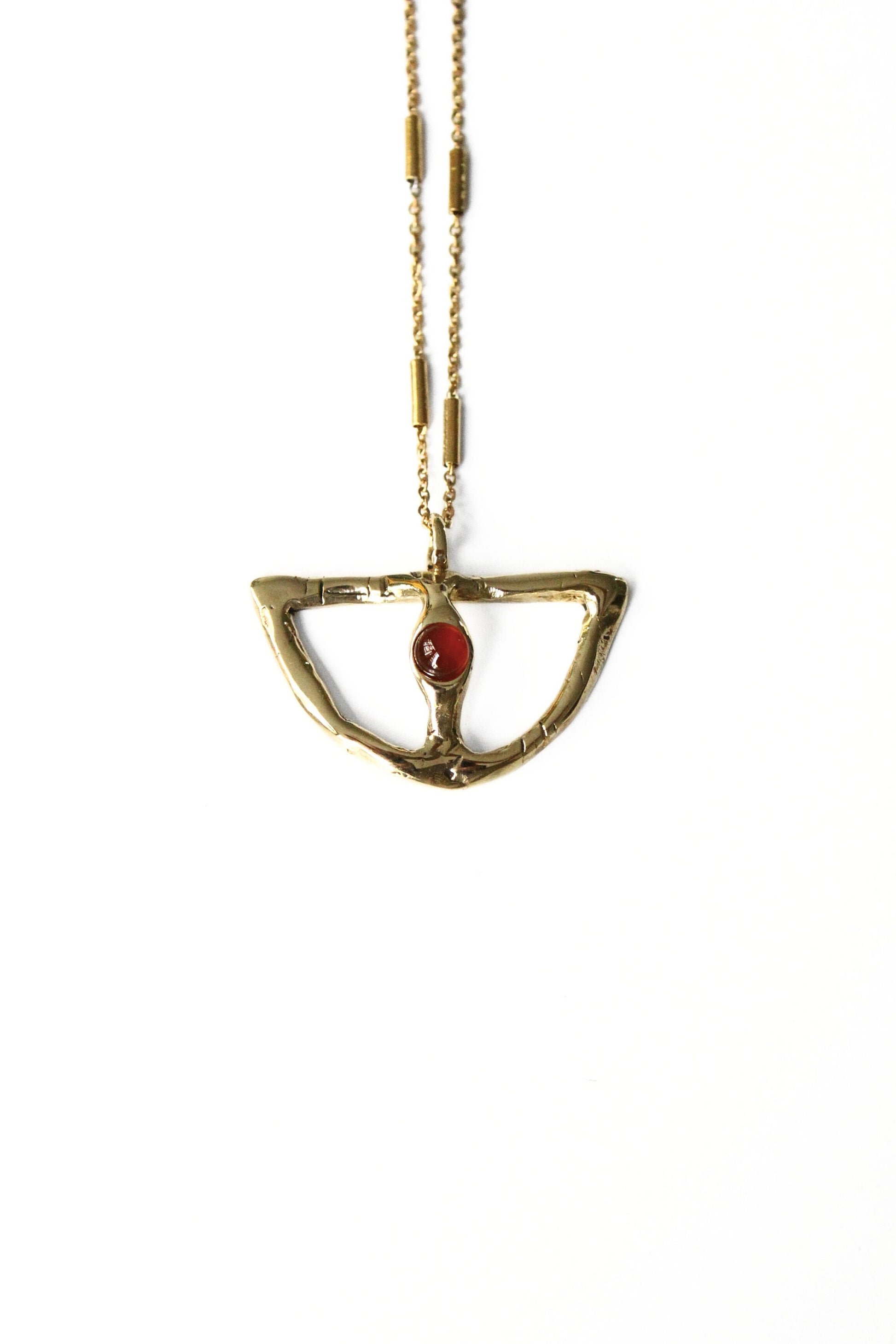 Gold necklace with a red carnelian gemstone pendant