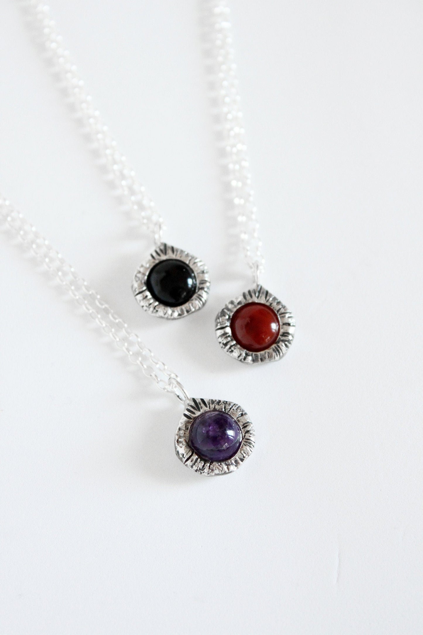 Gemstone pendants with black onyx crystal, amethyst and carnelian.