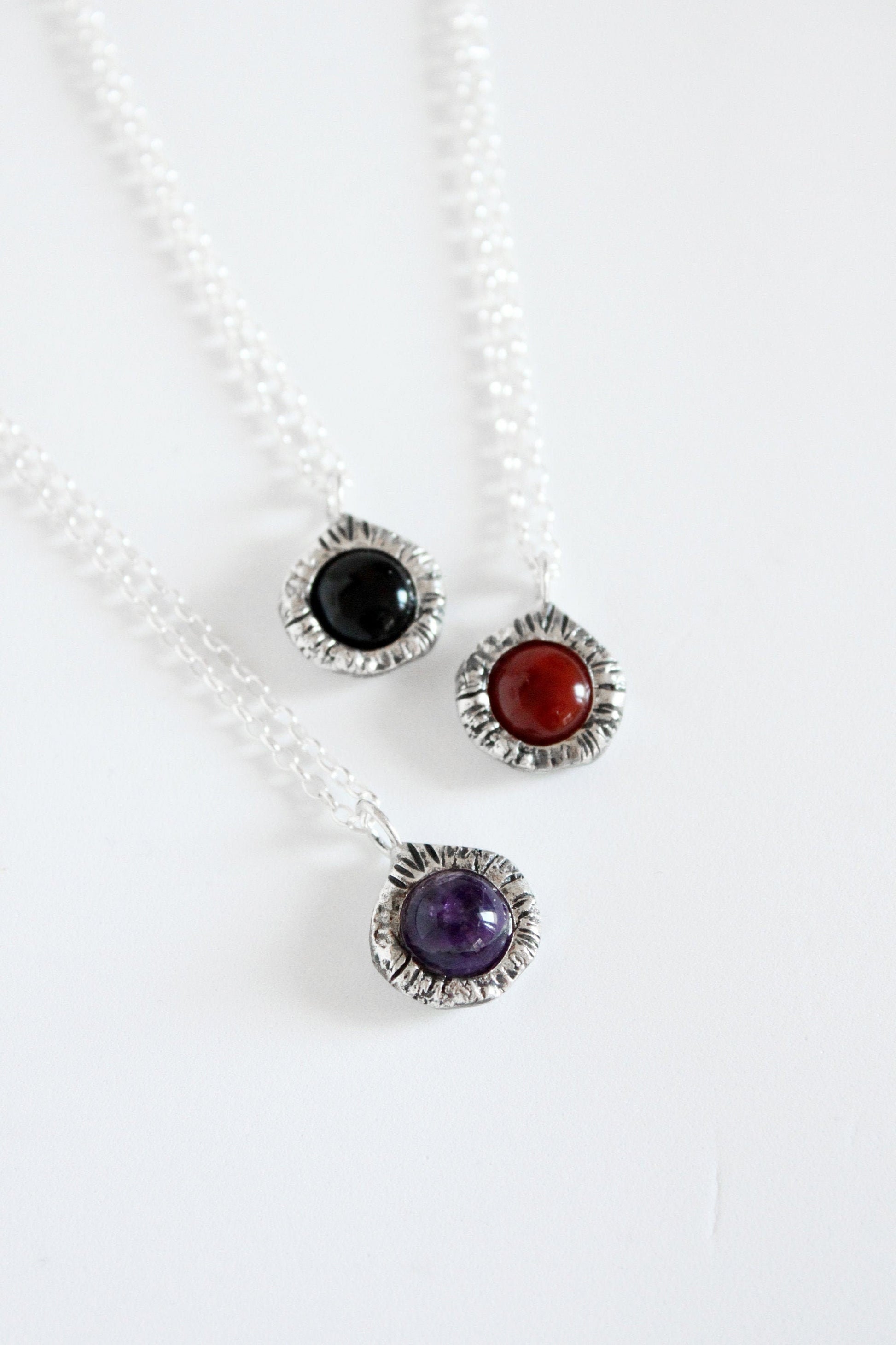 Gemstone pendants with black onyx crystal, amethyst and carnelian.