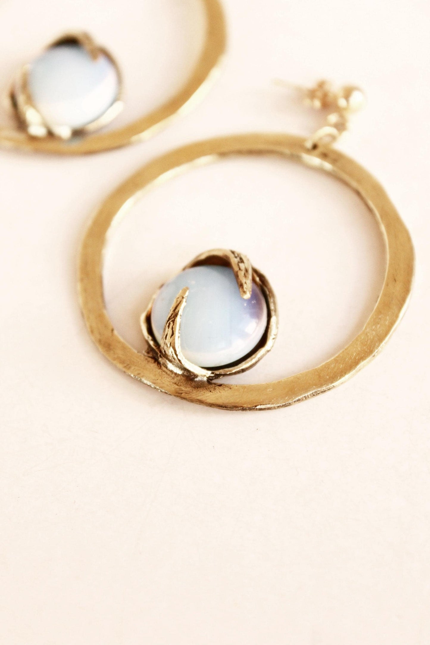 Gold circle statement earrings with light opal stones 